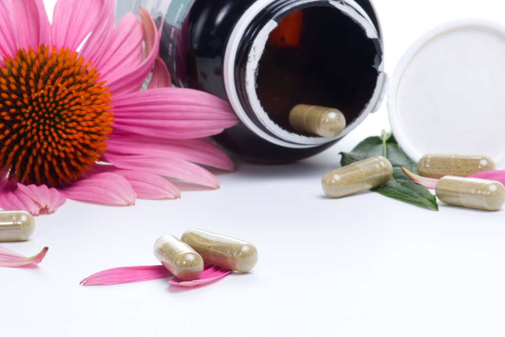 echinacea flower next to supplements and bottle