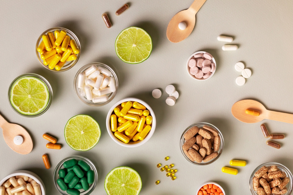 bowls of assorted supplements in various colors, shapes, and sizes